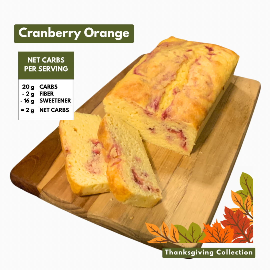 Cranberry Orange flavored pound cake on cutting board with 2 net carbs.